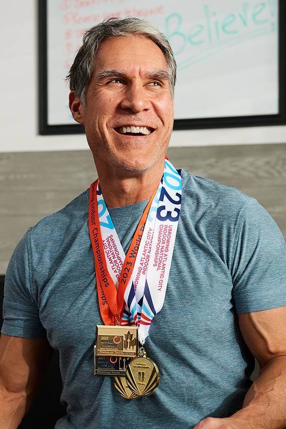 Indoor rowing world champion and personal trainer Steve Tague with gold and silver medals 2023