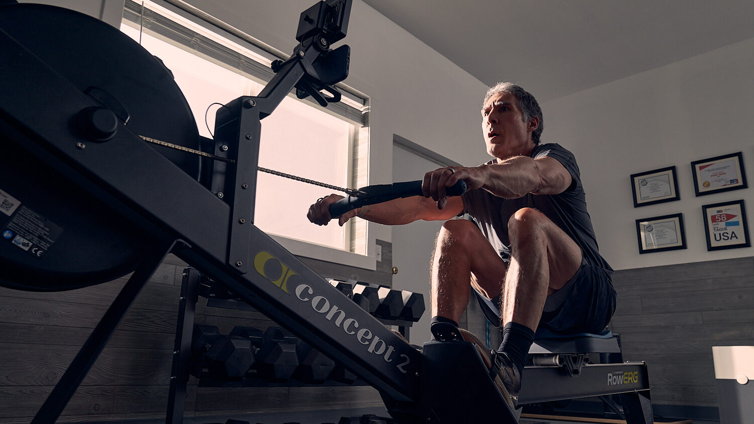 World Champion Indoor Rower Steve Tague on Concept2 RowErg, working out in gym.